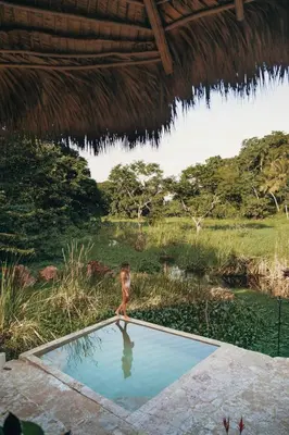 a woman is standing in a pool of water at El Valle Lodge in El Valle