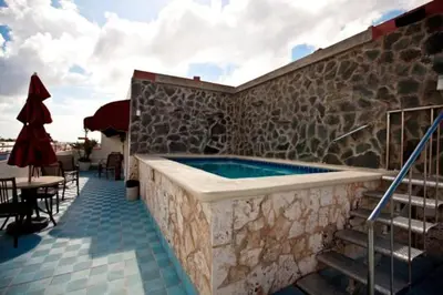 a swimming pool in the side of a building at Hotel Discovery in Santo Domingo