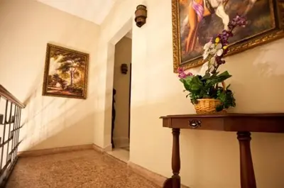 a hallway with a table and a painting on the wall at Hotel Discovery in Santo Domingo