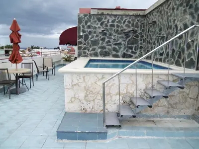 a swimming pool with stairs next to a building at Hotel Discovery in Santo Domingo