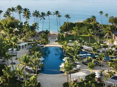 an aerial view of a resort with a pool and palm trees at Dreams La Romana All-Inclusive Resort & Spa in Bayahibe