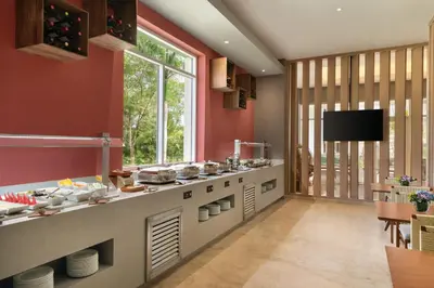 a kitchen with red walls and a large window at Secrets La Romana All-Inclusive Adult Only Resort & Spa in Bayahibe