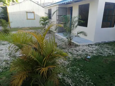 a house with palm trees in front of it at El Conde de Villa Rosa in Salado