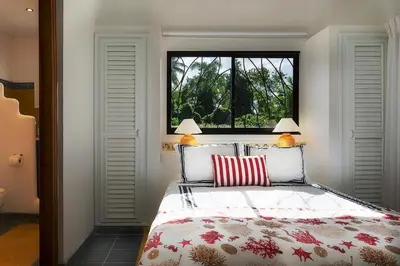 a bedroom with a bed and a window at Condo Hotel Playa Las Ballenas in Las Terrenas