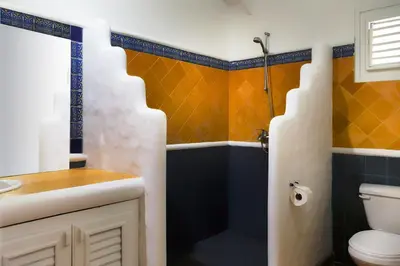 a bathroom with a toilet and a sink and a shower at Condo Hotel Playa Las Ballenas in Las Terrenas