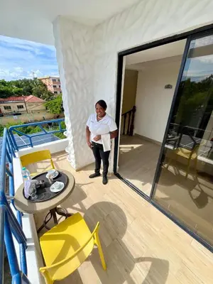 a man standing on the balcony of a house at Hotel Restaurant Hamilton in Boca Chica