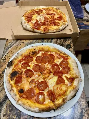 two pizzas sitting on top of a table at Hotel Restaurant Hamilton in Boca Chica
