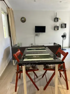 a table with four chairs in a living room at Villa Kate in Las Terrenas