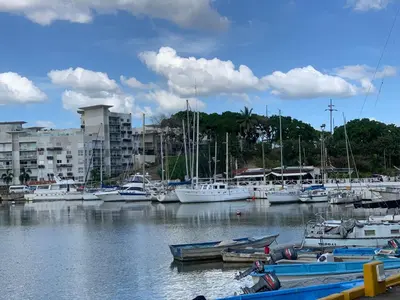 a bunch of boats docked in a marina with buildings at Mirador Colonial, en el Residencial Riviera Colonial in Santo Domingo