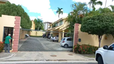 a man standing in front of a house at MiniHabitacion coqueta in Santo Domingo