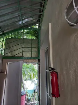 a room with a fire extinguisher on the side of a building at MiniHabitacion coqueta in Santo Domingo