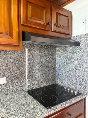 a kitchen with a black stove top oven at Hotel Checkin El Cortecito Beach in Punta Cana