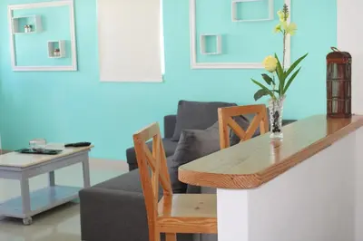 a living room with a table and a couch at Hotel Checkin El Cortecito Beach in Punta Cana