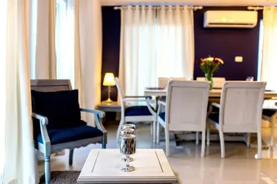 a dining room with chairs and a table with a glass at Hotel Checkin El Cortecito Beach in Punta Cana