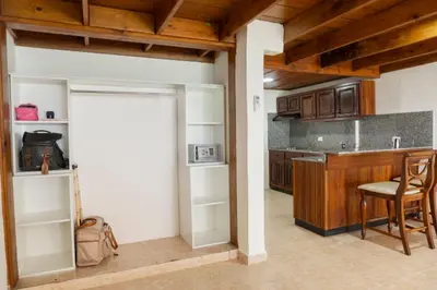 a kitchen with a door and a table and chairs at Hotel Checkin El Cortecito Beach in Punta Cana
