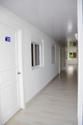 an empty hallway with white walls and a white door at Hotel Capriccio Mare y Restaurante in Punta Cana
