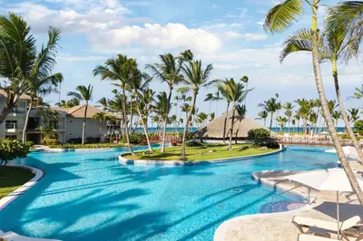 a pool at the resort with palm trees at Wyndham Alltra Punta Cana All Inclusive Resort in Punta Cana