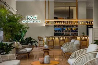 a restaurant with chairs and a bar and lounge at Wyndham Alltra Punta Cana All Inclusive Resort in Punta Cana