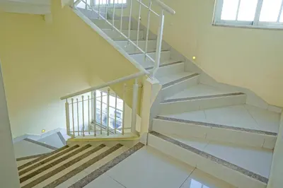 a staircase in a house with white walls at Hotel Shakey in Santo Domingo