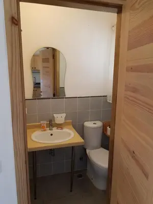 a bathroom with a sink and a toilet and a mirror at Las Palmeras RIKI R in Boca Chica