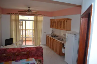 a kitchen with a refrigerator and a counter top at Las Palmeras RIKI R in Boca Chica