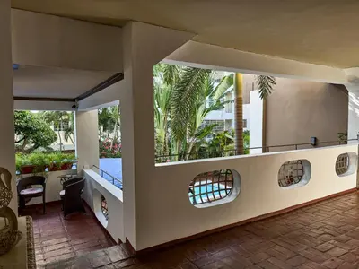 a house with a balcony with a view of a courtyard at Hotel San Marco in Santo Domingo
