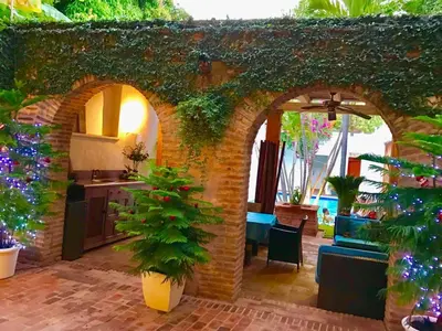 an outdoor kitchen with an archway in a house at Paseo Colonial - El Monasterio #4 in Santo Domingo