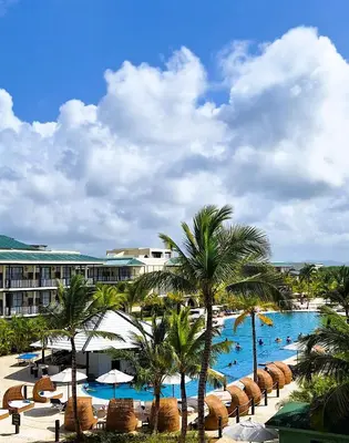 a view of a resort with a pool and palm trees at El Beso Adults Only At Ocean El Faro - All Inclusive in Punta Cana