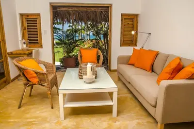 a living room with a couch and a table at Villa Flamboyan in Las Galeras