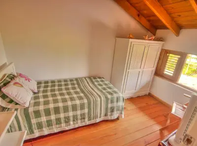 a bedroom with a bed with a plaid blanket at Villa Maxime in Las Galeras