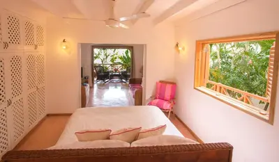 a bedroom with a bed and a window at Villa Maxime in Las Galeras