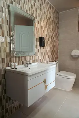a bathroom with a sink and a toilet and a mirror at Soficu Hotel El Edén Dominicus in Bayahibe