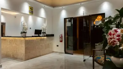 a lobby with a reception desk and flowers in at Soficu Hotel El Edén Dominicus in Bayahibe