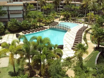 an aerial view of a resort pool with palm trees at Xeliter Balcones del Atlantico - Las Terrenas in Las Terrenas