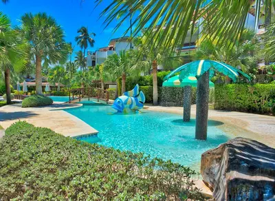 a pool in a resort with an elephant in the water at Xeliter Balcones del Atlantico - Las Terrenas in Las Terrenas