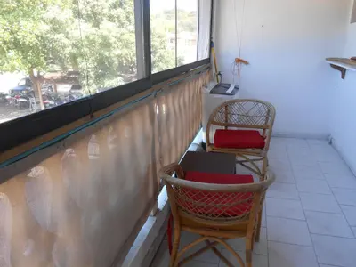 a balcony with two chairs and a window at 22 plaza rosada in Las Terrenas