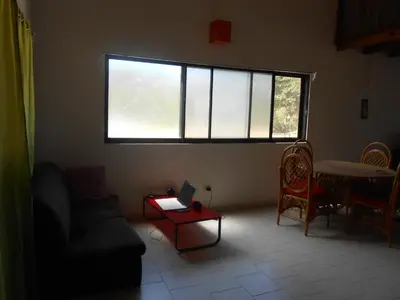 a living room with a window and a couch and a table at 22 plaza rosada in Las Terrenas
