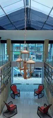 a chandelier in a room with chairs and a table at Hotel Frano Romana Center in La Romana