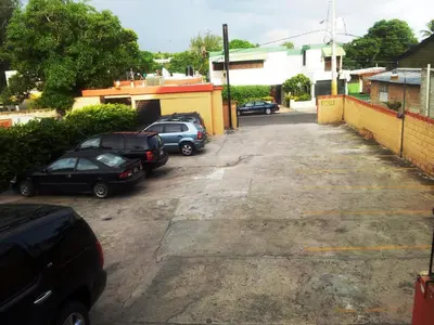 a group of cars parked in a parking lot at Hotel Boutique River View La Romana in La Romana