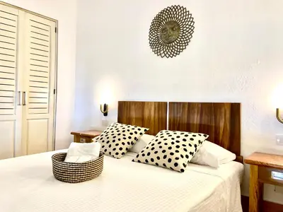 a bedroom with a bed with black and white pillows at Paseo Colonial - Sanctuary #2 in Santo Domingo