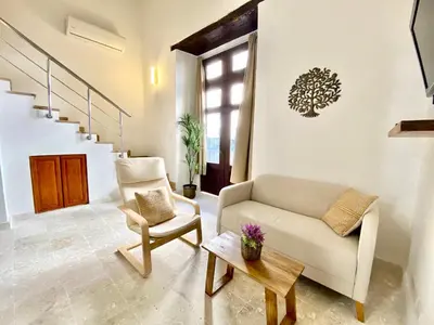 a living room with a couch and a chair at Paseo Colonial - Sanctuary #2 in Santo Domingo