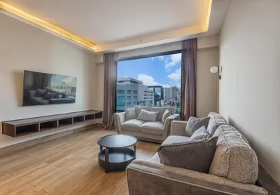 a living room with two couches and a large window at Weston Suites Hotel in Santo Domingo