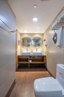 a bathroom with a toilet and a mirror at Weston Suites Hotel in Santo Domingo