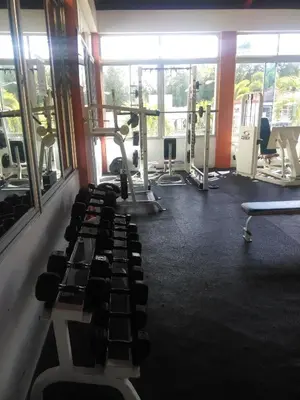 a gym with rows of exercise equipment in a room at SANTIAGO CITY in Santiago de los Caballeros