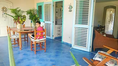 a young boy sitting in a chair at a table at La Dolce Vita 12 Beachfront Hotels, Las Terrenas, Samana in Las Terrenas