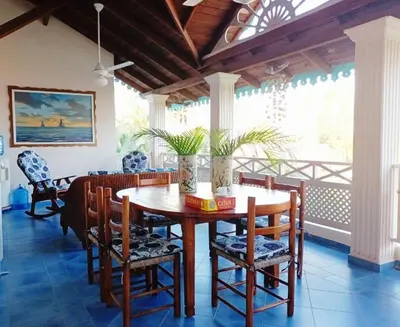 a dining room with a wooden table and chairs at La Dolce Vita 12 Beachfront Hotels, Las Terrenas, Samana in Las Terrenas