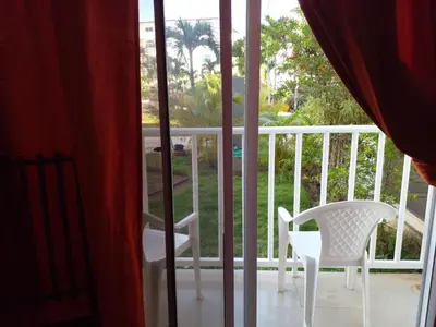 a white chair sitting on a balcony with a window at Apartamentos y habitaciones sol dominicus SOLO ADULTOS in La Laguna