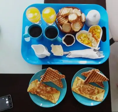 a blue tray with breakfast foods on a table at Apartamentos y habitaciones sol dominicus SOLO ADULTOS in La Laguna