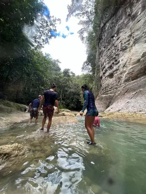 a group of people standing in a river at Surfbreak B&B in Cabarete