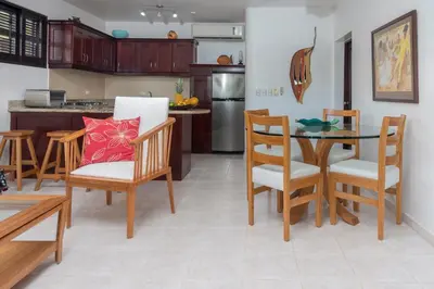 a kitchen and dining room with a table and chairs at Cabarete Palm Beach Condos in Cabarete